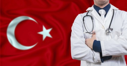 Male doctor with stethoscope on Turkey flag. Doctor holding stethoscope on Turkish flag