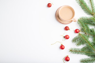 Christmas or New Year composition. Decorations, red balls, fir and spruce branches, cup of coffee,