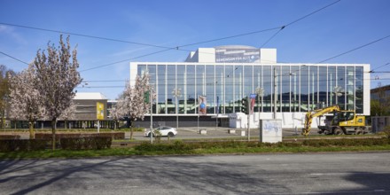 Music theatre in the Ruhr area by architect Werner Ruhnau with blossoming cherry tree (Prunus) in