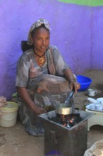 In the highlands of Abyssinia, in the village of Sina, young woman roasting coffee for the coffee