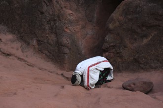 Lalibela, eastern group of rock-hewn churches, pilgrims praying at the Prayer of Abba Lebanon, Abba