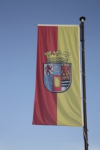 Flag and flagpole with coat of arms at Oberstein Castle, Idar-Oberstein, Hunsrück,