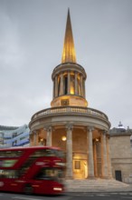 Red double-decker bus in front of All Souls Langham Place, Church of John Nash, evening mood,