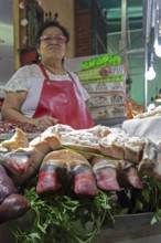 Oaxaca, Mexico, A vendor sells bull's feet and other meats at the Benito Juarez Market. Opened in