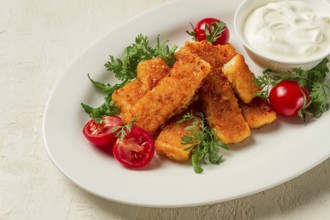 Fried fish nuggets, with white sauce, arugula and cherry, no people