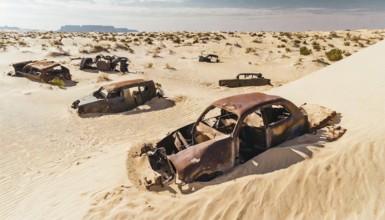 Rusty cars buried and abandoned in a vast, sandy desert landscape, symbolic photo, AI generated, AI