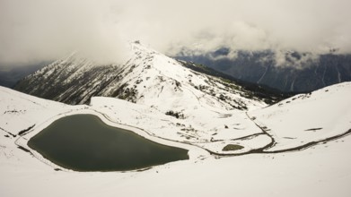 Onset of winter in May, Riezler Alpsee, an artificial lake, snow pond, feeds the snow cannons that