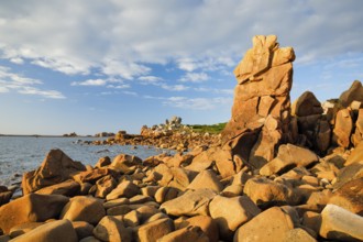 Striking orange-coloured rock formations in the evening light, on the coast of the English Channel