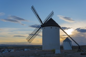 Windmills at dusk with a bright sky in the background, Campo de Criptana, Ciudad Real province,