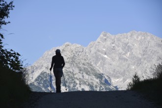 Single woman on a hike in the Berchtesgaden National Park with the Watzmann and the Watzmann east