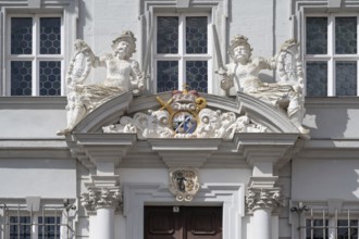 Entrance potal with sculptures and coat of arms of the baroque town hall, built in 1718, Iphofen,