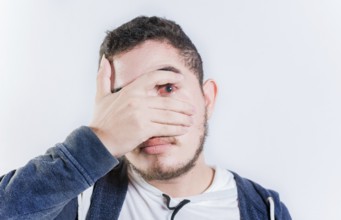 Unhappy man with conjunctivitis isolated. Person with irritated eyes looking at camera