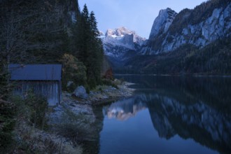 The Vordere Gosausee lake in autumn with a view of the Dachstein mountain range. The Gosaukamm on