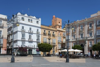 Urban square with colourful historic buildings and trees under a blue sky, Plaza de San Antonio,