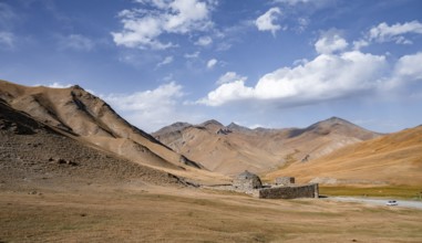 Historic caravanserai Tash Rabat from the 15th century, with yellow hills, Atbashy district in the