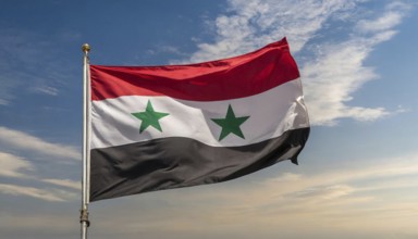 The flag of Syria flutters in the wind