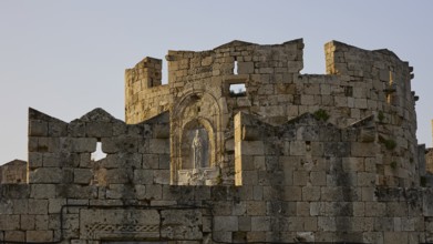 Dilapidated historical ruin under the warm light of the rising sun, Tor tor of St Paul, harbour