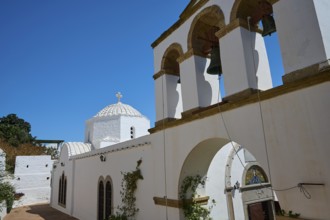 Cross-domed church Diasososuan, White church with a bell tower and several arches, blue sky in the