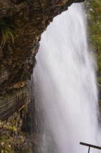 Close-up of a waterfall flowing down next to steep rocks, Lake Brienz, Switzerland, Europe