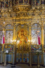 Interior of an Orthodox church with gold-decorated icons and religious artworks, Panaghia Church,