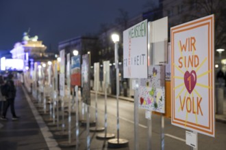 Signs painted by children with the words Menschen machen Freiheit and Wir sind 1 Volk to mark the