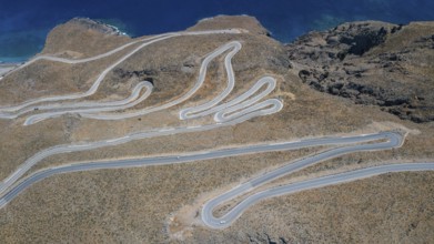 Aerial view of pass road serpentines from to Passo Anopoli above south coast of Crete at top of