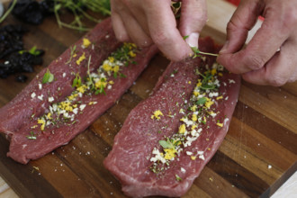 Swabian cuisine, preparation of lamb with prunes, raw lamb stuffed with herbs, rosemary, sliced