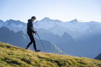 Hiker enjoying the mountain panorama in the morning, Venediger group, behind Dreiherrenkopf,