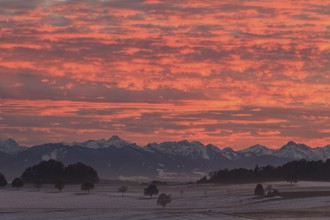 Sunset over mountains, snow, cloudy mood, view of Bavarian Alps, foothills of the Alps, Bavaria,