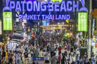 Crowds of people on Bangla Street in the evening. Nightlife on Bangla Walking Street with go-go