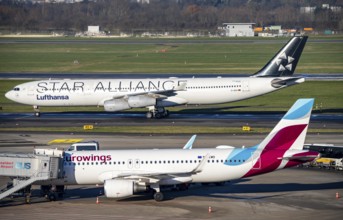 Lufthansa Airbus A340 on the way to take-off, Eurowings Airbus at the terminal, at Düsseldorf