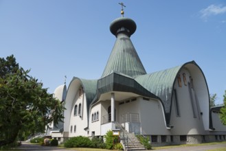 Modern church with green roof and cross under a blue sky, Holy Trinity Cathedral, Hajnówka,