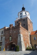 Gothic tower with clock against a blue sky, Krakow Tor, Brama Krakowska, Lokietka Square, Lublin,