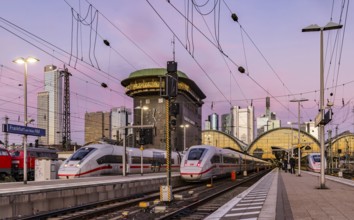 Frankfurt main station with ICE in the evening, sunset. View of platform and banking district,