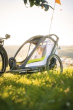 Modern bicycle trailer in a meadow in the soft light of dusk, e-bike, forest bike, Calw, district