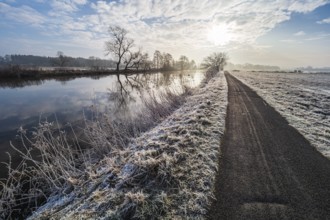 River Aller on a frozen winter day, hiking and cycling path along the river, between Celle and