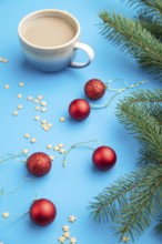 Christmas or New Year composition. Decorations, red balls, fir and spruce branches, cup of coffee,