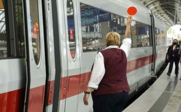 Train attendant of an ICE shows signal for departure, Berlin, 21/09/2021