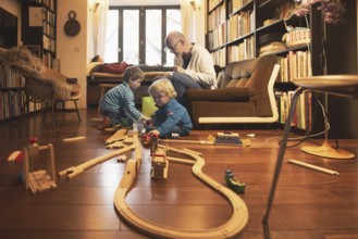 Playing children, two and four years old and their grandfather, in the family, Bonn, 24.12.2023. In