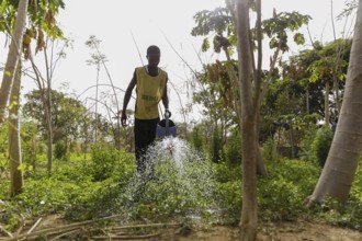 Watering of fields by farmers during organic farming at the agroecological training centre Centre