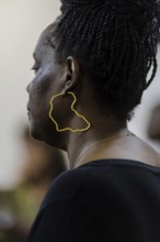 Woman wearing an earring showing the outline of the continent of Africa, Berlin, 07.03.2024