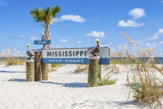 Sign at the beach welcomes visitors to the Mississippi Gulf Coast at Gulfport, Mississippi, USA,