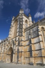 14th century built Santa Maria da Vitoria Monastery with arched entrance door, Batalha, Portugal,