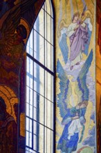 Window with frescoes and tiles in the Church of the Savior on Spilled Blood in the city of Saint