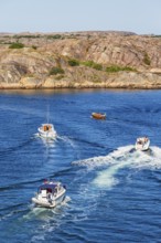 Boats on the sea by a rocky coast in the archipelago on the Swedish west coast on a sunny summer