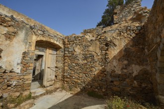 A crumbling building with open doors and stone walls standing in daylight, Venetian Sea Fortress,