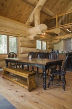 Black stained antique wood dining table with rounded high back chairs and pine wood sitting bench