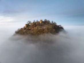 Aerial view of the Hegau volcano Hohentwiel with the upper fortress ruins illuminated by the rising