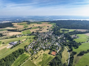 Aerial view of the municipality of Schienen on the Schienerberg mountain range, on the horizon to