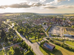 Wide view of a green landscape criss-crossed by roads, fields and hills at sunset, Weil der Stadt,